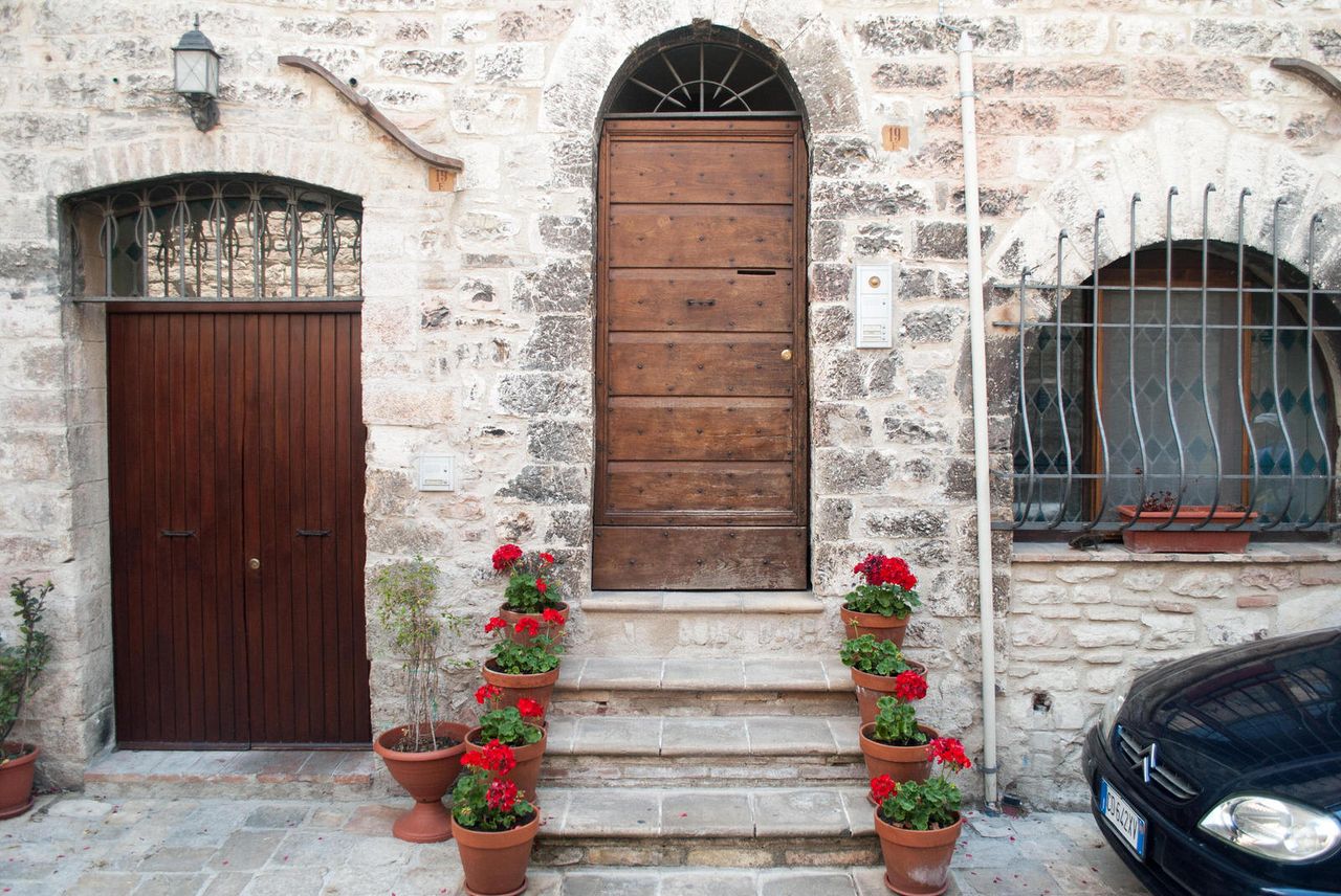 Flowers neatly line the staircase to a home in Assisi.