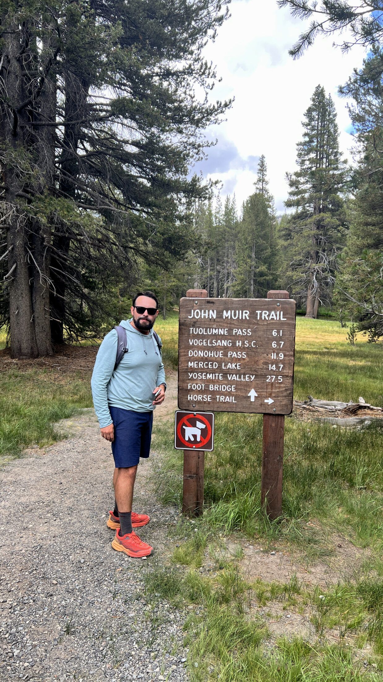 Sam Solomon standing in front of the John Muir trailhead near Tuolumne Meadows.