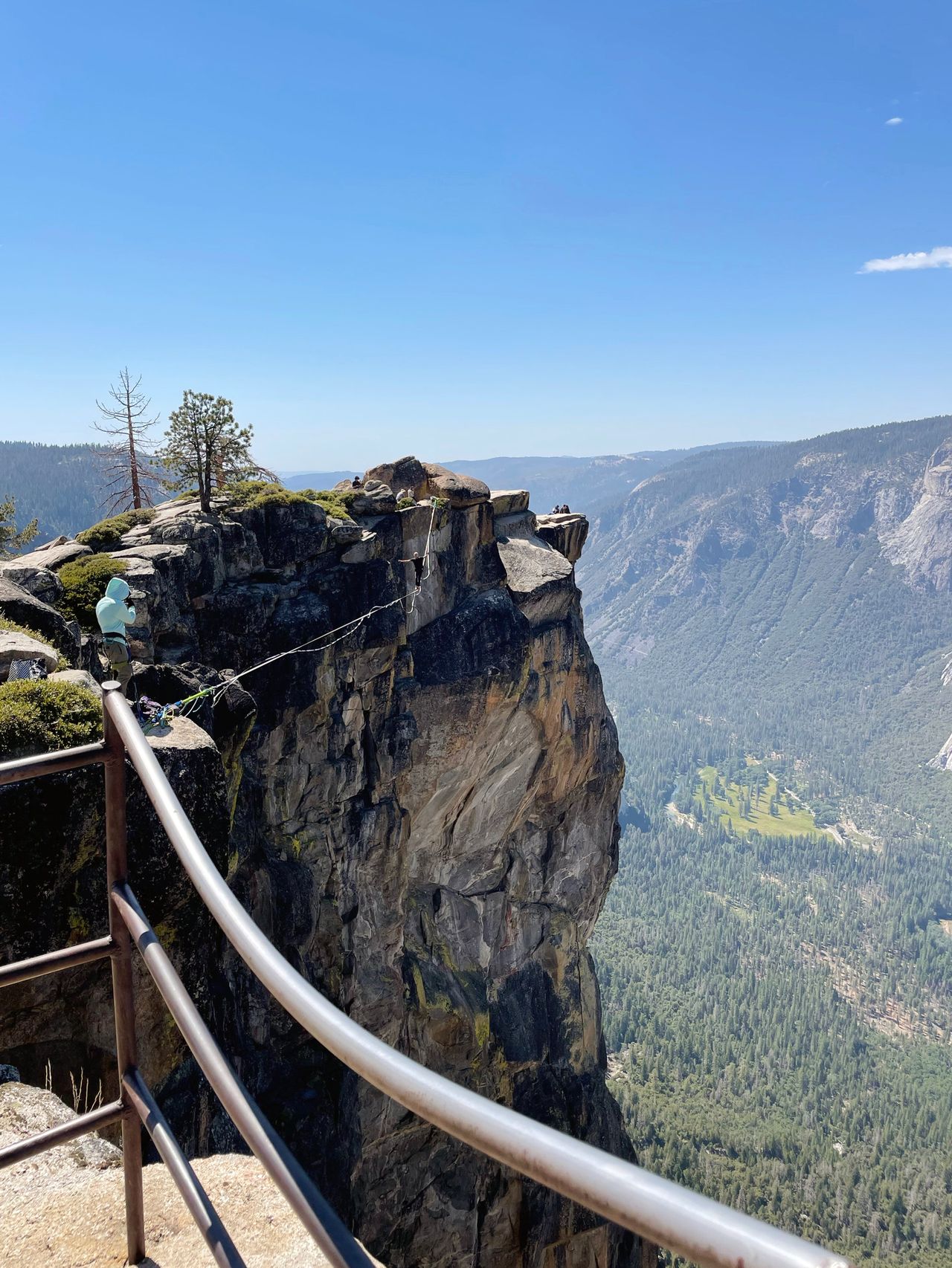 Someone walking a slackline at Taft Point.