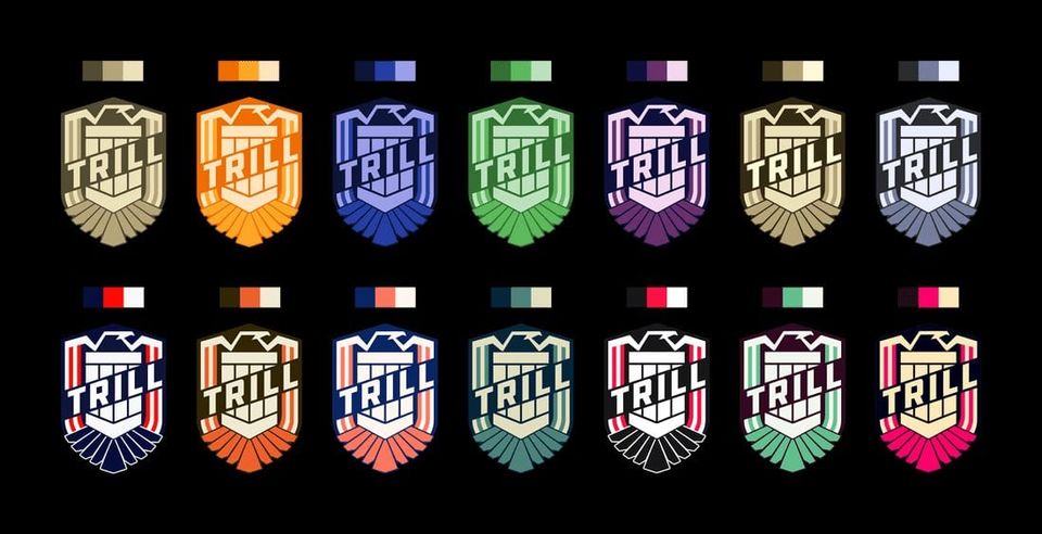 Fourteen shield-shaped Trill badges in different color palettes, each with a three-color swatch above