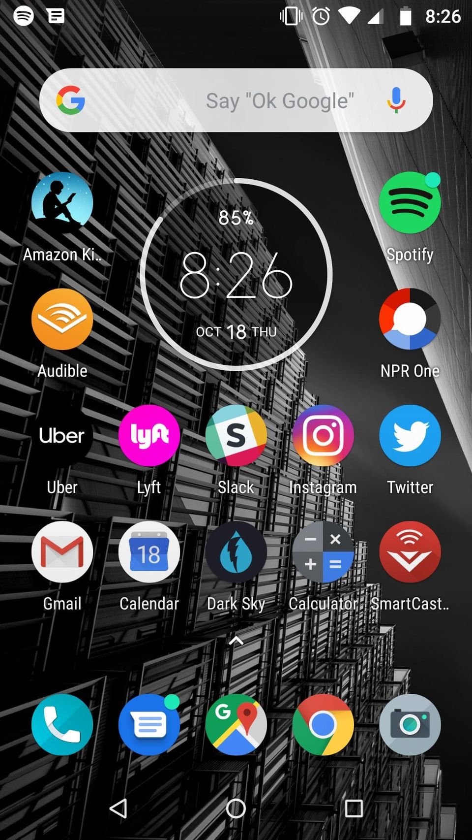 Android home screen with a clock widget reading 8:26, app icons like Spotify and Slack and a Messages badge