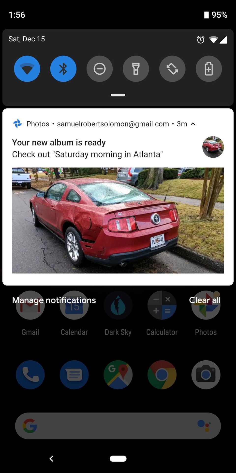 Google Photos notification reading Your new album is ready, Saturday morning in Atlanta, showing a dented red Mustang