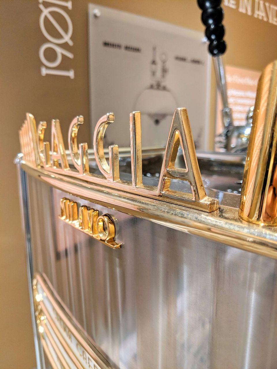 Gold Gaggia Milano lettering on a vintage chrome espresso machine