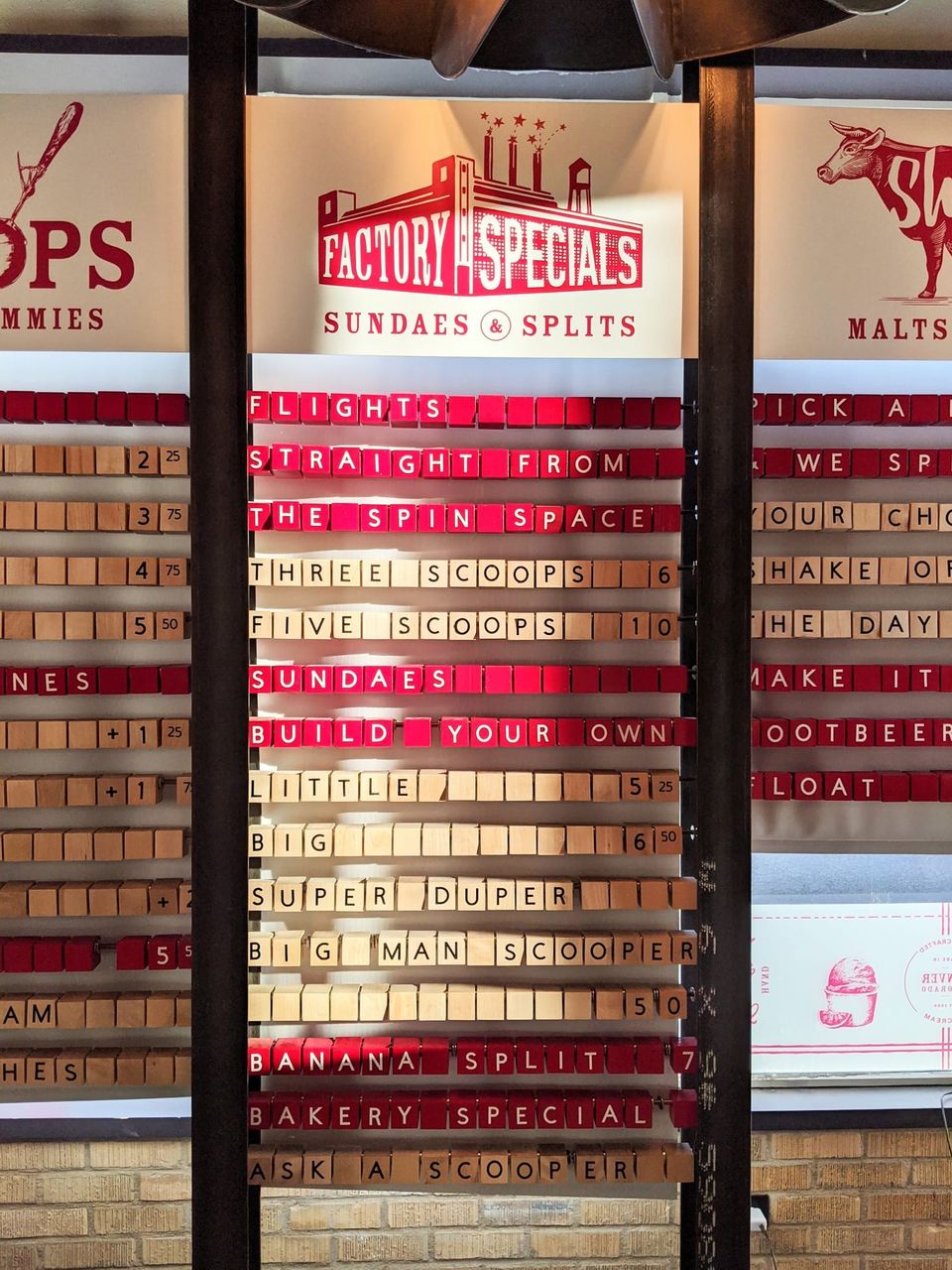 Factory Specials menu of wooden letter blocks listing flights, sundaes, banana split and Big Man Scooper