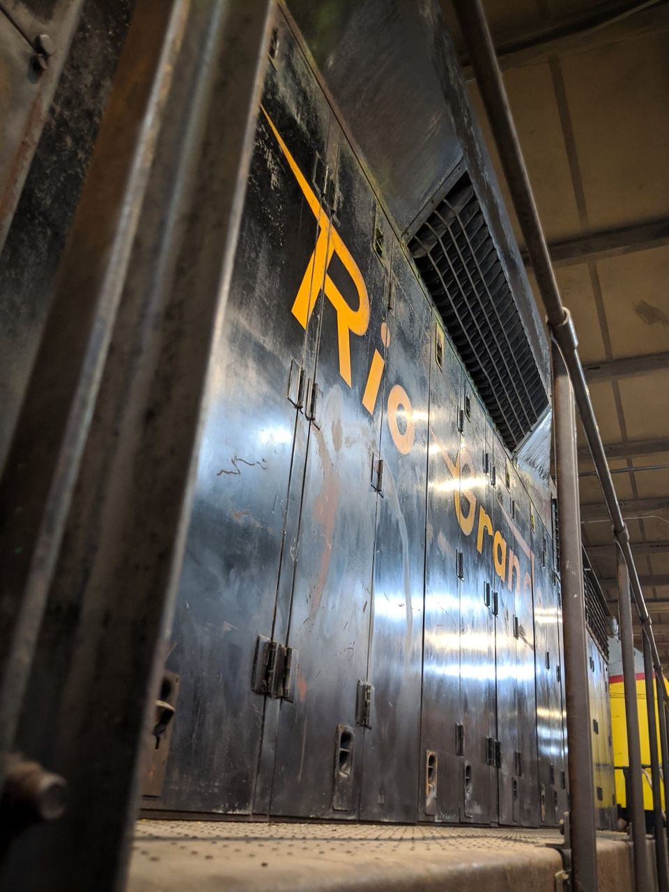 Black locomotive side with Rio Grande lettered in orange, viewed from its walkway