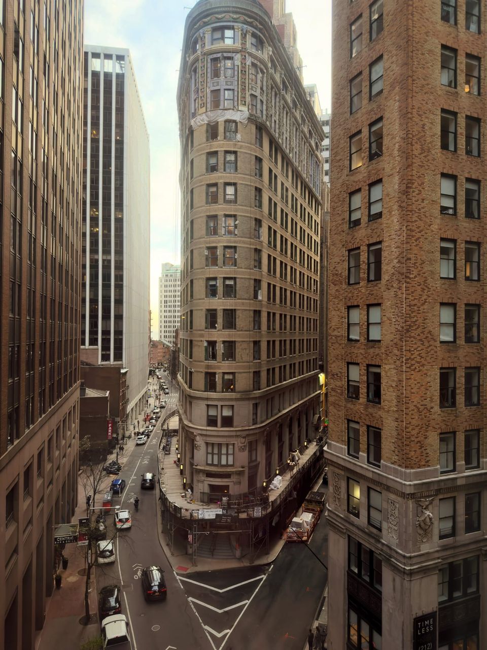 Rounded flatiron-style tower at a narrow Financial District intersection seen from above