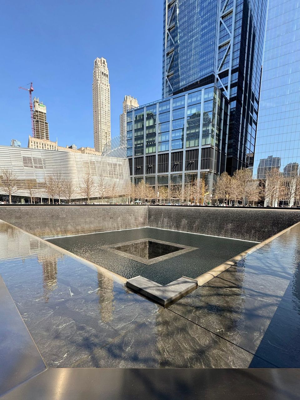 9/11 Memorial reflecting pool with water falling into a central void