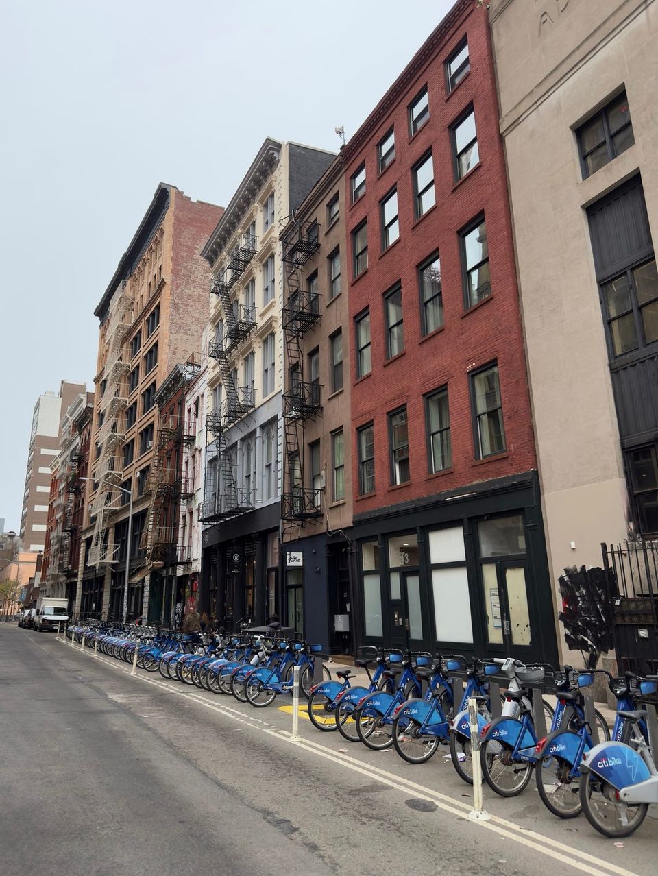 SoHo street of cast-iron buildings with a long row of Citi Bike docks