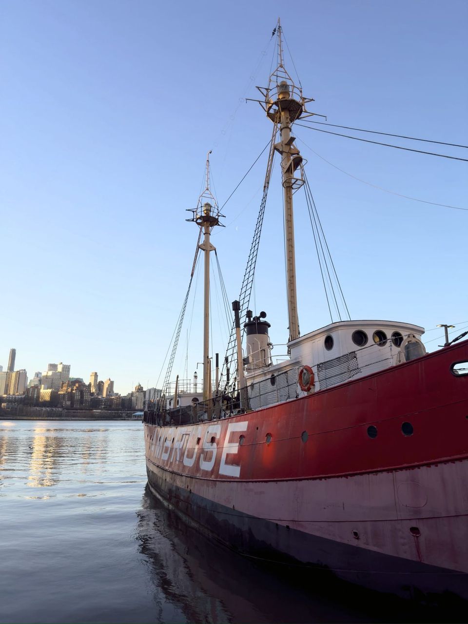 Red Ambrose lightship moored on the East River with the Brooklyn skyline behind