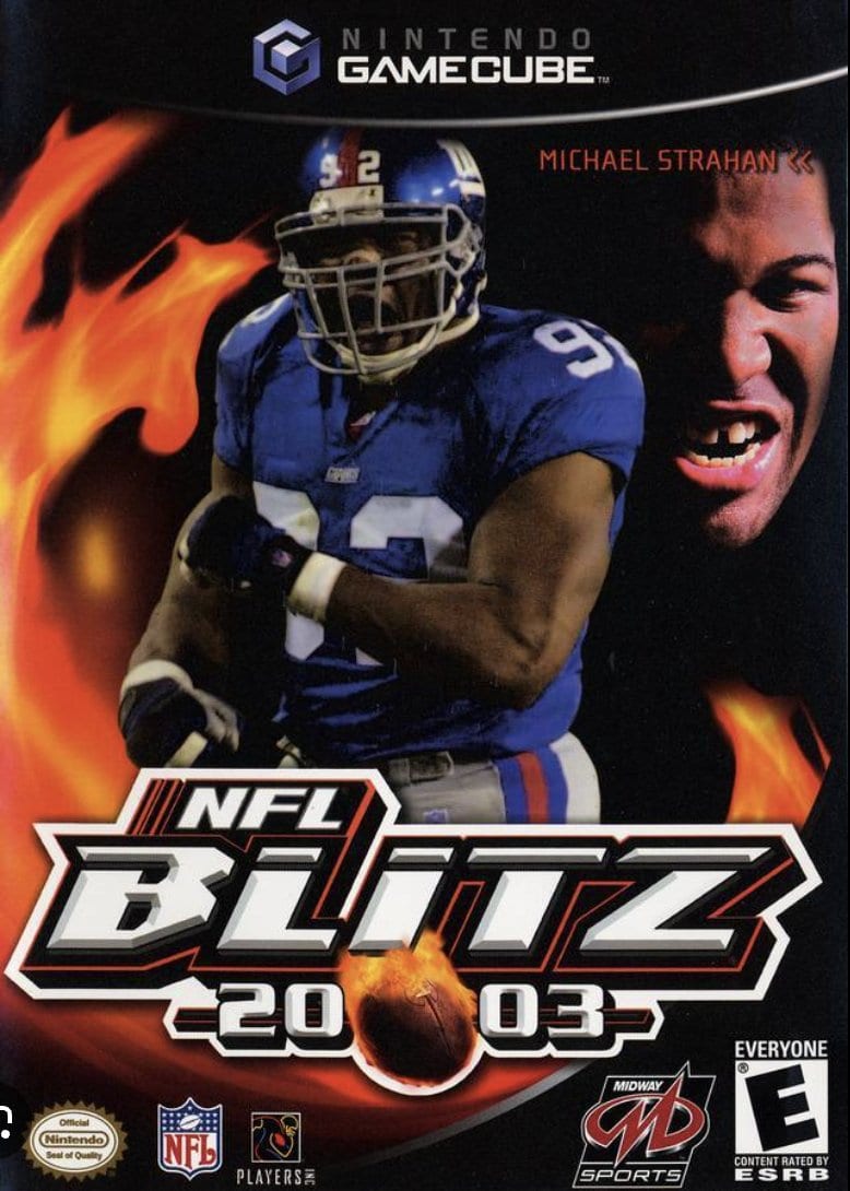 NFL Blitz 2003 GameCube cover featuring Michael Strahan in a blue Giants jersey against flames