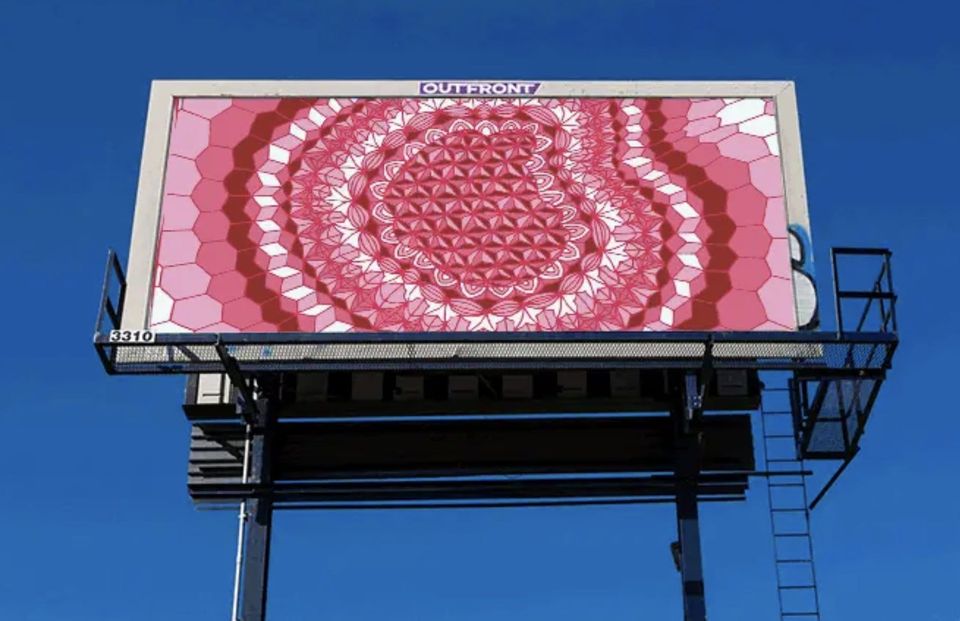 Billboard of an intricate pink and red geometric mandala pattern