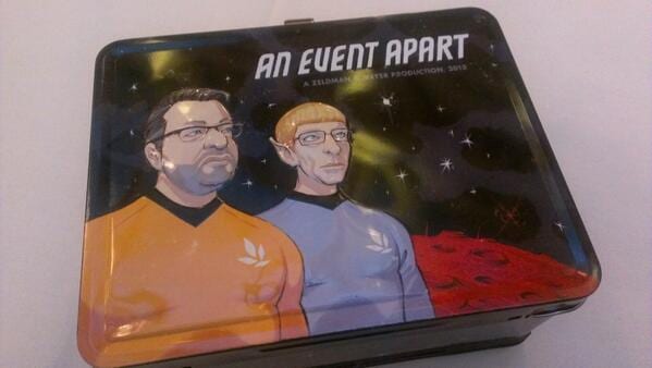 An Event Apart lunchbox illustrated with two men in Star Trek uniforms, one with Spock ears, against a starfield