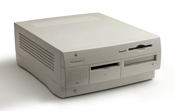 Beige Apple Power Macintosh G3 desktop tower with PowerPC branding and front drive bays