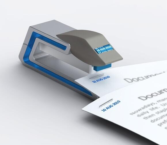 Silver and blue stapler concept stamping 10 AUG 2010 next to the staple on a document