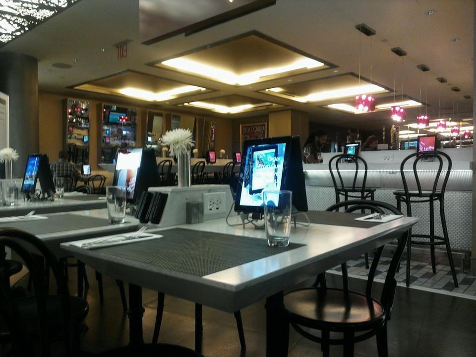 Restaurant with a tablet standing on every table showing ordering screens