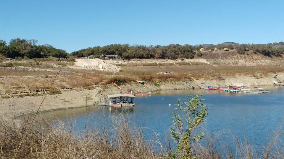 Cachuma Lake marina with docks sitting low beside exposed dry banks and hills