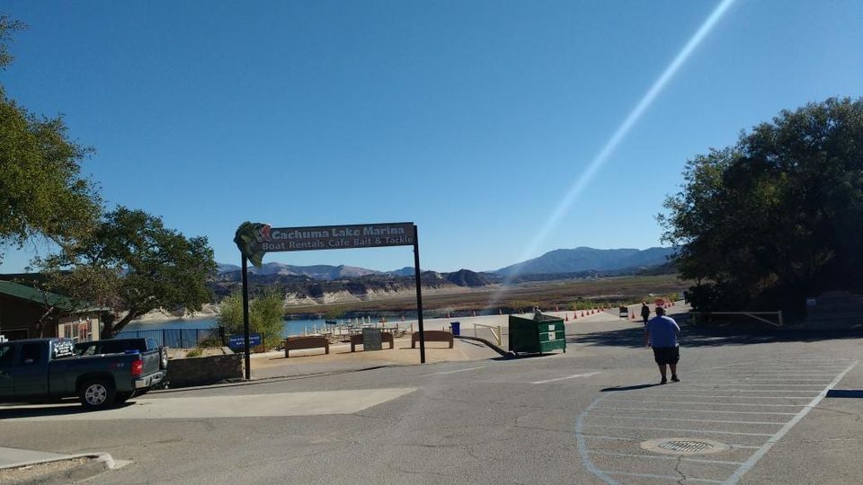 Cachuma Lake Marina sign reading Boat Rentals Cafe Bait & Tackle with the lowered lake behind it