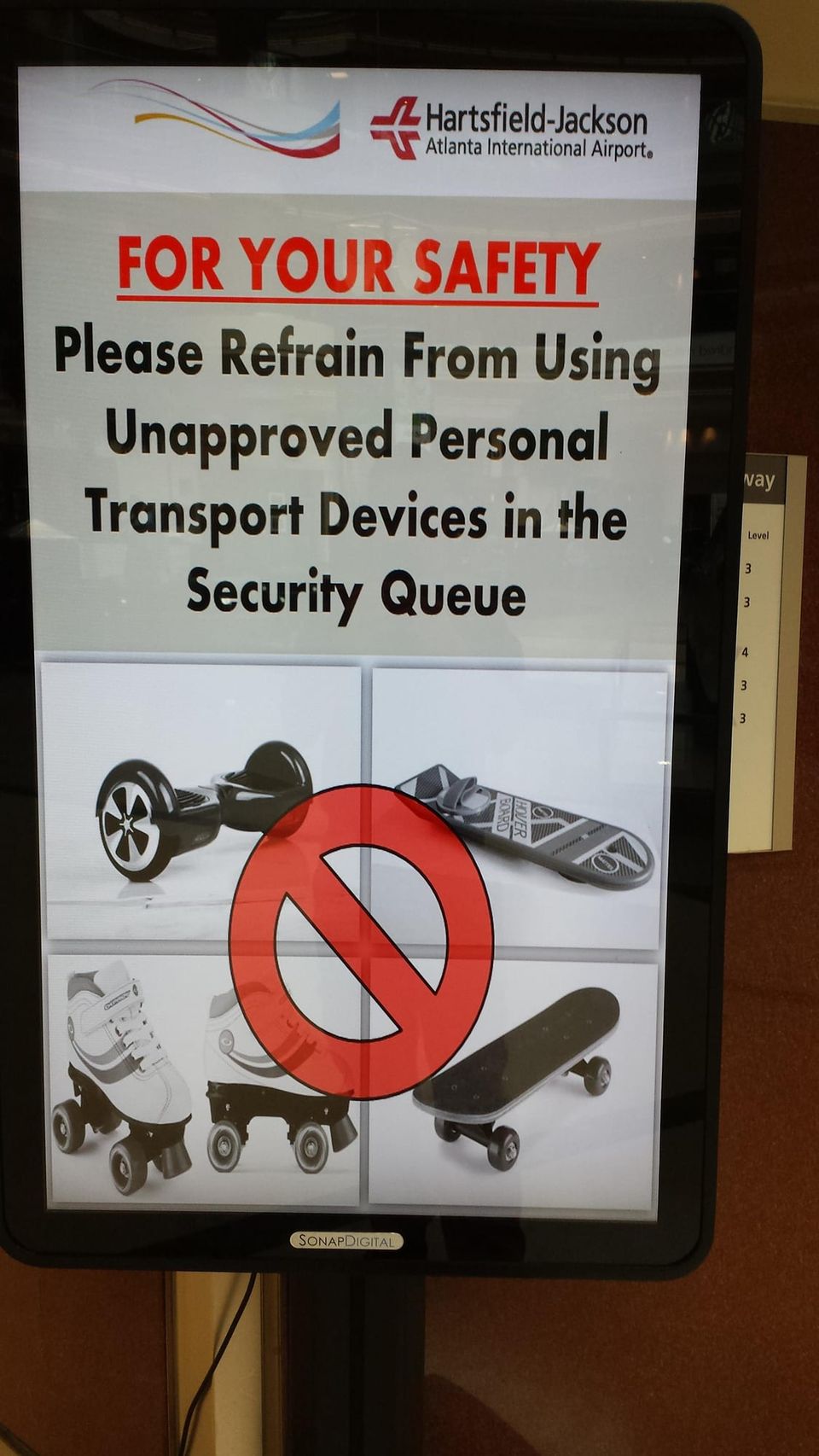 Hartsfield-Jackson sign asking travelers not to use hoverboards, skates or skateboards in the security queue