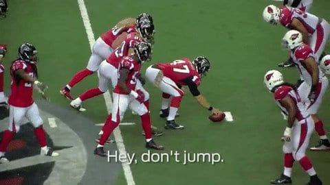Falcons lined up against the Cardinals at the line of scrimmage with the caption Hey, don't jump