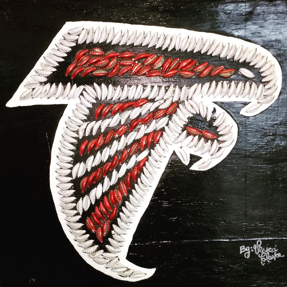 Atlanta Falcons logo made from red and white bottle caps on a black painted board