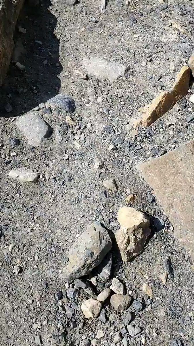 Rocky gravel trail with scattered stones in bright sun