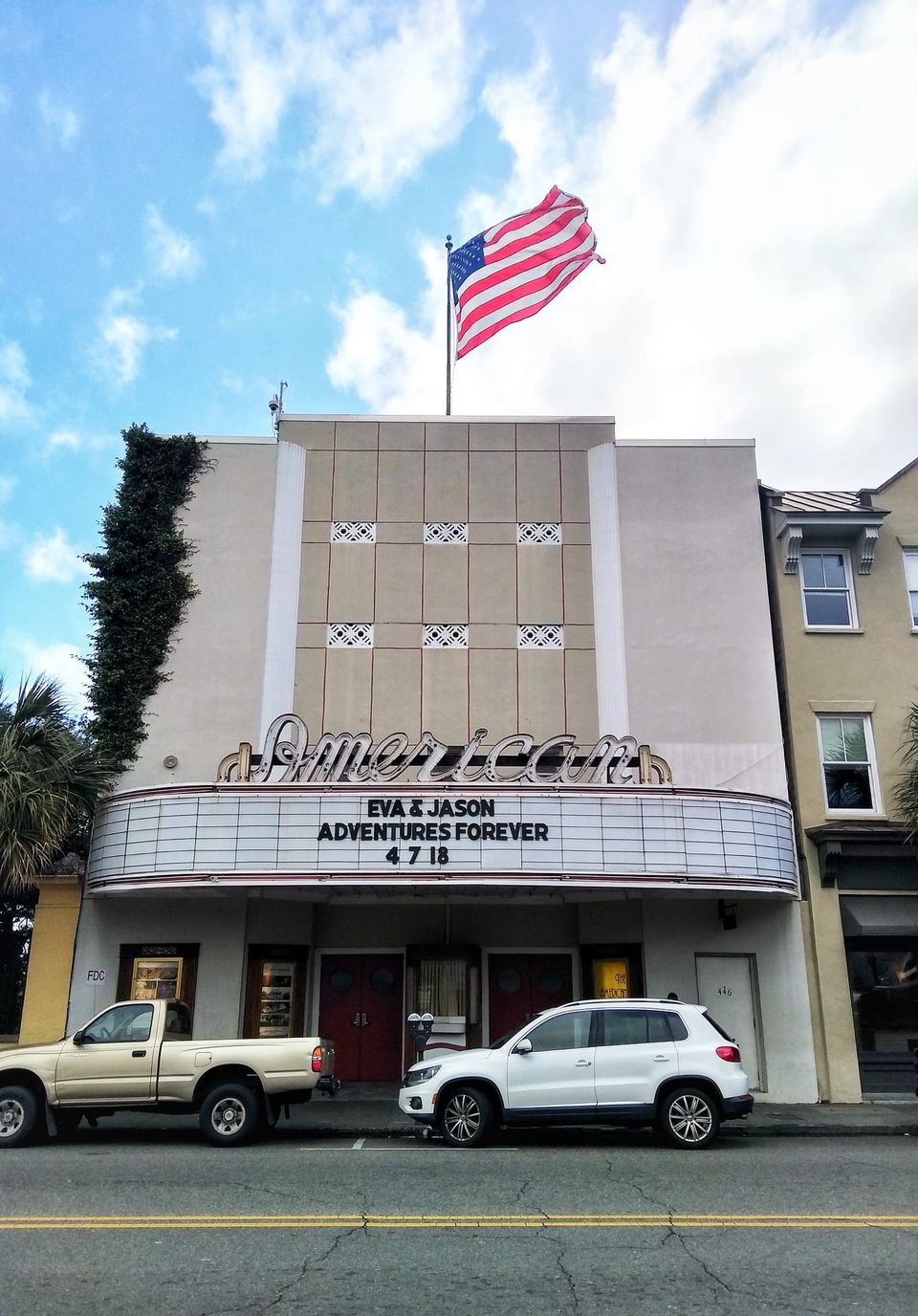American Theater with a flag on top and a marquee reading Eva & Jason Adventures Forever 4 7 18