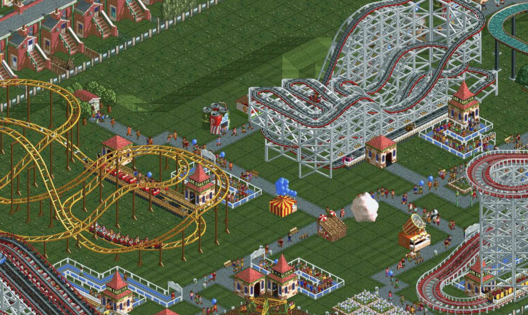 Isometric pixel art screenshot from RollerCoaster Tycoon showing a busy theme park with wooden and steel roller coasters, guests, and carnival stalls